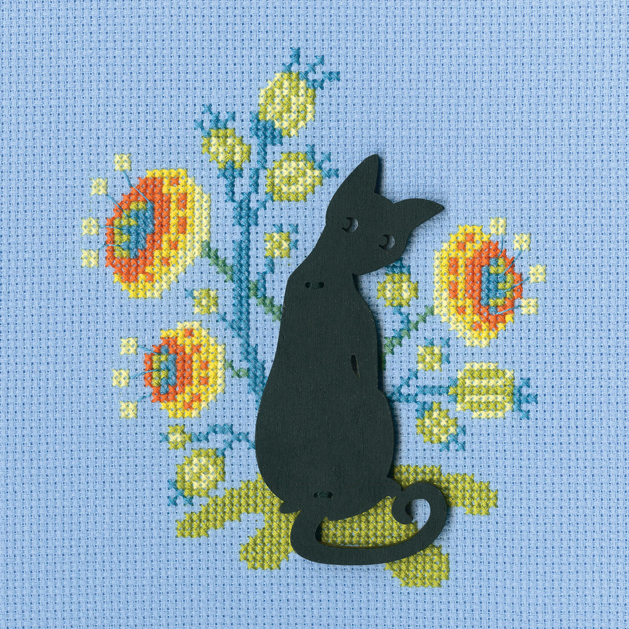 Cat CBE9008 Cross stitch kit featuring light blue Aida canvas, DMC threads, and a plywood form for display.